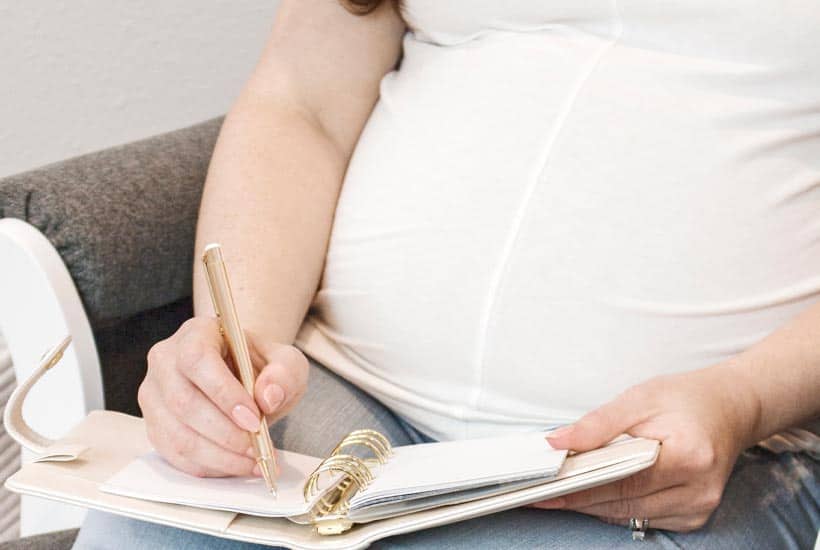 new mom writing out netflix inspired baby name